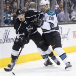 Los Angeles Kings defenseman Drew Doughty, left, sends the puck away from San Jose Sharks center Patrick Marleau during the first period in Game 2 of a second-round NHL hockey Stanley Cup playoff series, Thursday, May 16, 2013, in Los Angeles. (AP Photo/Mark J. Terrill)