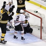 Boston Bruins left wing Milan Lucic, left, reacts after scoring past Chicago Blackhawks defenseman Duncan Keith (2) and goalie Corey Crawford, hidden during the third period in Game 6 of the NHL hockey Stanley Cup Finals, Monday, June 24, 2013, in Boston. (AP Photo/Charles Krupa)