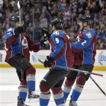  Colorado Avalanche right wing P.A. Parenteau (15) celebrates his goal against the Phoenix Coyotes with teammates Matt Duchene (9), and Nick Holden (2) during the first period of an NHL hockey game on Friday, Feb. 28, 2014, in Denver. (AP Photo/Jack Dempsey)
