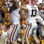 Georgia place kicker Marshall Morgan (13) celebrates with Jay Rome (87) as Arthur Lynch (88) holds up his hands in overtime of an NCAA college football game against Tennessee on Saturday, Oct. 5, 2013, in Knoxville, Tenn. Georgia won 34-31. (AP Photo/Wade Payne)