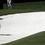 Lee Westwood of England hits out of a bunker during a practice round the Masters golf tournament Wednesday, April 6, 2011, in Augusta, Ga. (AP Photo/Dave Martin)
 