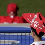 A young fan wears a fish-shaped foam hat in honor of Los Angeles Angels center fielder Mike Trout during an exhibition spring training baseball game against the Seattle Mariners Monday, Feb. 25, 2013, in Peoria, Ariz. (AP Photo/Charlie Riedel)