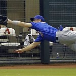 Chicago Cubs' Cole Gillespie can't reach a double by Arizona Diamondbacks' Cliff Pennington during the fourth inning of a baseball game, Thursday, July 25, 2013, in Phoenix. (AP Photo/Matt York)