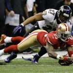 San Francisco 49ers cornerback Tarell Brown, bottom, picks up a fumble by Baltimore Ravens running back Ray Rice during the second half of the NFL Super Bowl XLVII football game, Sunday, Feb. 3, 2013, in New Orleans. (AP Photo/Marcio Sanchez)