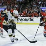 Boston Bruins left wing Brad Marchand (63) controls the puck against Chicago Blackhawks defenseman Niklas Hjalmarsson (4) in the first period during Game 5 of the NHL hockey Stanley Cup Finals, Saturday, June 22, 2013, in Chicago. (AP Photo/Nam Y. Huh)
