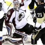 Colorado Avalanche goalie Jean-Sebastien Giguere (35) celebrates a 1-0 shutout win over the Pittsburgh Penguins as time runs out in the third period of an NHL hockey game in Pittsburgh Monday, Oct. 21, 2013. At right is Penguins' Evgeni Malkin (71). (AP Photo/Gene J. Puskar)