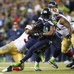 Seattle Seahawks' Marshawn Lynch, center, rushes against the San Francisco 49ers in the second half of an NFL football game, Sunday, Sept. 15, 2013, in Seattle. The Seahawks won 29-3. (AP Photo/John Froschauer)