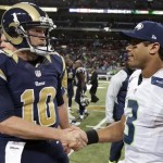 St. Louis Rams quarterback Kellen Clemens (10) shakes hand with Seattle Seahawks quarterback Russell Wilson (3) after an NFL football game, Monday, Oct. 28, 2013, in St. Louis. The Seahawks won 14-9. (AP Photo/Michael Conroy)