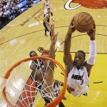 Miami Heat small forward LeBron James (6) dunks the ball as San Antonio Spurs power forward Tim Duncan (21) defends during the first half of Game 6 in the NBA Finals basketball series, Tuesday, June 18, 2013, in Miami. (AP Photo/Kevin C. Cox, Pool)