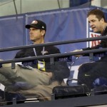San Francisco 49ers coach Jim Harbaugh, left, and his brother, Baltimore Ravens coach John Harbaugh watch from the stands as players run a drill during the NFL football scouting combine in Indianapolis, Saturday, Feb. 23, 2013. (AP Photo/Dave Martin)
