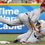 Cincinnati Reds' Drew Stubbs, right, is forced out at second base as Arizona Diamondbacks second baseman Aaron Hill, left, throws out Reds' Zack Cozart at first base to complete a double play in the first inning of a baseball game, Monday, July 16, 2012, in Cincinnati. (AP Photo/David Kohl)