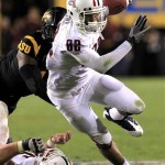 Arizona's Juron Criner (82) breaks a tackle on his way to a touchdown against Arizona State during the fourth quarter of an NCAA college football game Saturday, Nov. 19, 2011, in Tempe, Ariz. Arizona defeated Arizona State 31-27. (AP Photo/Ross D. Franklin)