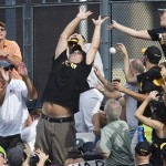 Fans reach for a home run by Pittsburgh Pirates' Pedro Alvarez to right field in the third inning of the Pirates' baseball game against the Arizona Diamondbacks on Saturday, Aug. 17, 2013, in Pittsburgh. (AP Photo/Keith Srakocic)