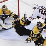 Chicago Blackhawks left wing Brandon Saad (20) takes down Boston Bruins defenseman Andrew Ference (21) in front of Bruins goalie Tuukka Rask (40), of Finland, during the third period in Game 4 of the NHL hockey Stanley Cup Finals, Wednesday, June 19, 2013, in Boston. (AP Photo/Charles Krupa)