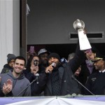 Baltimore Ravens linebacker Ray Lewis, holding the Vince Lombardi trophy, speaks to fans at a celebration at City Hall at the start of a Super Bowl victory parade Tuesday, Feb. 5, 2013, in Baltimore. Super Bowl MVP and Ravens quarteback Joe Flacco, third from left, smiles. The Ravens defeated the San Francisco 49ers in NFL football's Super Bowl XLVII 34-31 on Sunday. (AP Photo/Gail Burton)