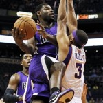 Sacramento Kings' Tyreke Evans tries to drive around Phoenix Suns' Jared Dudley (3) as Kings' Jason Thompson, back left, looks on during the first half of an NBA preseason basketball game, Monday, Oct. 22, 2012, in Phoenix. (AP Photo/Ross D. Franklin)