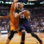  New Orleans Pelicans' Anthony Davis (23) drives past Phoenix Suns' Miles Plumlee during the first half of an NBA basketball game, Friday, Feb. 28, 2014, in Phoenix. (AP Photo/Matt York)