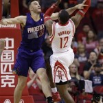  Houston Rockets' Dwight Howard (12) goes up for a shot as Phoenix Suns' Miles Plumlee (22) defends during the first quarter of an NBA basketball game Wednesday, Dec. 4, 2013, in Houston. (AP Photo/David J. Phillip)