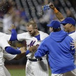 New York Mets' Andrew Brown, center, celebrates his game winning single during the 13th inning of the baseball game against the Arizona Diamondbacks at Citi Field, Tuesday, July 2, 2013, in New York. The Mets beat the Diamondbacks 5-4. (AP Photo/Seth Wenig)