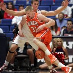 UTEP's Cedrick Lang (31) mishandles the ball as he drives into the defense of Arizona's Kaleb Tarcrewski, in back, during the first half of an NCAA college basketball game at McKale Center in Tucson, Ariz., Thursday, Nov.15, 2012. (AP Photo/John Miller)