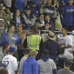 San Diego police with the help of Petco Park security make an arrest while breaking up a fight in the stands during baseball game between the San Diego Padres and the Los Angeles Dodgers in San Diego, Thursday, April 11, 2013. The Padres and Dodgers engaged in a brawl in the sixth inning before fights broke out in the stands. wbb(AP Photo/Lenny Ignelzi)
