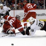 Detroit Red Wings goalie Jimmy Howard (35) stops a shot as Anaheim Ducks left wing Matt Beleskey (39) dives for the rebound during the first period in Game 2 of a first-round NHL hockey Stanley Cup playoff series in Detroit, Saturday, May 4, 2013. (AP Photo/Paul Sancya)