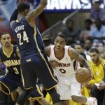 Atlanta Hawks point guard Jeff Teague (0) works against Indiana Pacers small forward Paul George (24) during the second half in Game 4 of their first-round NBA basketball playoff series game, Monday, April 29, 2013 in Atlanta. (AP Photo/John Bazemore)