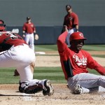 Cincinnati Reds' Denis Phipps, right, scores past Arizona Diamondbacks catcher Miguel Montero, left, after a sacrifice fly from Neftali Soto during the second inning of an exhibition spring training baseball game, Wednesday, Feb. 27, 2013, in Scottsdale, Ariz. (AP Photo/Marcio Jose Sanchez)