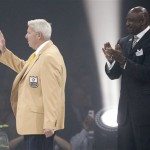 Bill Parcells waves to the crowd after receiving his symbolic gold jacket from his presenter George Martin, right, during the Enshrinees' Gold Jacket Dinner at the Canton Memorial Civic Center Friday, Aug. 2, 2013 in Canton, OH. Parcells will be enshrined into the Pro Football Hall of Fame Saturday. (AP Photo/The Repository, Scott Heckel)

