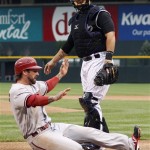 Arizona Diamondbacks' Ryan Roberts, front, slides safely across home 
plate as he scores on a single by Chris Young while Colorado Rockies 
catcher Ramon Hernandez looks on in the first inning of a baseball 
game in Denver on Saturday, April 14, 2012. (AP Photo/David 
Zalubowski)