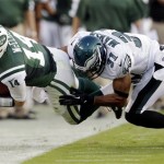  New York Jets quarterback Greg McElroy (14) is tackled out of bounds by Philadelphia Eagles defensive back Curtis Marsh in the first half of a preseason NFL football game, Thursday, Aug. 30, 2012, in Philadelphia. (AP Photo/Matt Rourke)