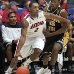 Arizona's Mark Lyons (2) dribbles around Southern Mississippi's Deon Edwin (15) during the first half of an NCAA college basketball game in Tucson, Ariz.,Tuesday, Dec. 4, 2012. (AP Photo/John Miller)
