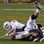 Arizona's Nick Foles (8) is sacked by Arizona State's Carl Bradford (52) during the second quarter of an NCAA college football game Saturday, Nov. 19, 2011, in Tempe, Ariz. (AP Photo/Ross D. Franklin)