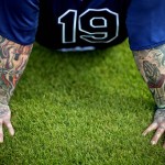 Tattoos decorate the arms of Tampa Bay Rays' Ryan Roberts as he takes a rest during a spring training baseball workout, Thursday, Feb. 21, 2013, Port Charlotte, Fla. (AP Photo/David Goldman)