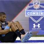 Missouri defensive lineman Michael Sam stretches before drills at the NFL football scouting combine in Indianapolis, Monday, Feb. 24, 2014. (AP Photo/Michael Conroy)