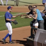 Texas Rangers' David Murphy signs autographs as he leaves the field during the seventh inning of an exhibition spring training baseball game against the Chicago Cubs Wednesday, March 6, 2013, in Surprise, Ariz. (AP Photo/Charlie Riedel)