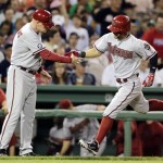 Arizona Diamondbacks' Cody Ross, right, is congratulated by third base coach Matt Williams as he rounds the bases after a solo home run in the seventh inning of a baseball game against the Boston Red Sox at Fenway Park, Friday, Aug. 2, 2013, in Boston. (AP Photo/Charles Krupa)
