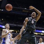 Michigan State forward Adreian Payne (5) reacts as he dunks during the first half of a regional semifinal against Duke in the NCAA college basketball tournament, Friday, March 29, 2013, in Indianapolis. Watching at left is Duke's Mason Plumlee (5). (AP Photo/Michael Conroy)