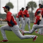 St. Louis Cardinals starting pitcher Adam Wainwright, left, stretches with teammates during spring training baseball, Thursday, Feb. 14, 2013, in Jupiter, Fla. (AP Photo/Julio Cortez)