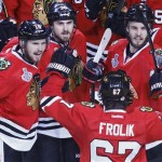 The Chicago Blackhawks celebrate a late third period goal against the Boston Bruins during Game 5 of the NHL hockey Stanley Cup Finals, Saturday, June 22, 2013, in Chicago. The Blackhawks won 3-1. (AP Photo/Charles Rex Arbogast)
