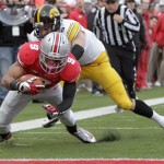 Ohio State wide receiver Devin Smith, front, scores a touchdown as Iowa defensive back Tanner Miller tries to stop him during the third quarter of an NCAA college football game Saturday, Oct. 19, 2013, in Columbus, Ohio. Ohio State beat Iowa 34-24. (AP Photo/Jay LaPrete)