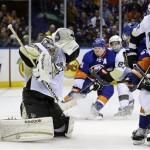 Pittsburgh Penguins goalie Marc-Andre Fleury, front left, defends the goal during the overtime period of Game 3 of an NHL hockey Stanley Cup first-round playoff series against the New York Islanders, Sunday, May 5, 2013, in Uniondale, N.Y. The Penguins defeated the Islanders 5-4. (AP Photo/Seth Wenig)
