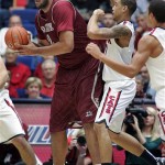  New Mexico States' Sim Bhullar, left, looks to pass the ball against the defense of Arizona's Brandon Ashley, right, in the first half of an NCAA college basketball game on Wednesday, Dec. 11, 2013 in Tucson, Ariz. (AP Photo/John MIller)