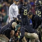  Baylor head coach Art Briles, top left, Glasco Martin (8) and Shock Linwood (32) watch as staff members attend to an injured Lache Seastrunk, bottom, in the first half of an NCAA college football game against Oklahoma, Thursday, Nov. 7, 2013, in Waco, Texas. (AP Photo/Tony Gutierrez)