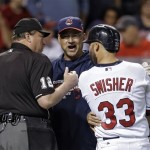 Cleveland Indians manager Terry Francona center, argues with home plate umpire Gerry Davis after Nick Swisher (33) struck out against the Tampa Bay Rays in the first inning of the AL wild-card baseball game Wednesday, Oct. 2, 2013, in Cleveland. (AP Photo/Tony Dejak)