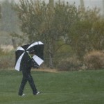 Hunter Mahan makes his way along the 10th fairway as snow and rain fall during the Match Play Championship golf tournament, Tuesday, Feb. 19, 2013, in Marana, Ariz. Play was suspended. (AP Photo/Ross Franklin)