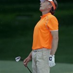 Bernhard Langer, of Germany, reacts to his hit out of a bunker on the seventh hole during the fourth round of the Masters golf tournament Sunday, April 14, 2013, in Augusta, Ga. (AP Photo/David J. Phillip)
