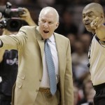San Antonio Spurs' Gregg Popovich and referee Tony Brothers (25) discuss action during the first half at Game 5 of the NBA Finals basketball series against the Miami Heat, Sunday, June 16, 2013, in San Antonio. (AP Photo/Eric Gay)
