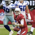 Arizona Cardinals quarterback Kevin Kolb (4) shows his frustration after being sacked by Dallas Cowboys' Jay Ratliff (90) as Cowboys' Sean Lee (50) looks on during the second quarter of an NFL football game, Sunday, Dec. 4, 2011, in Glendale, Ariz. (AP Photo/Ross D. Franklin)