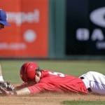 Italy's Anthony Granato, left, tags out Los Angeles Angels' Trent Oeltjen during the third inning of an exhibition spring training baseball game on Wednesday, March 6, 2013, in Tempe, Ariz. Oeltjen tried to stretch a single into a double and was tagged out on the play. (AP Photo/Morry Gash)
